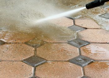 Pressure washing octagonal brick driveway